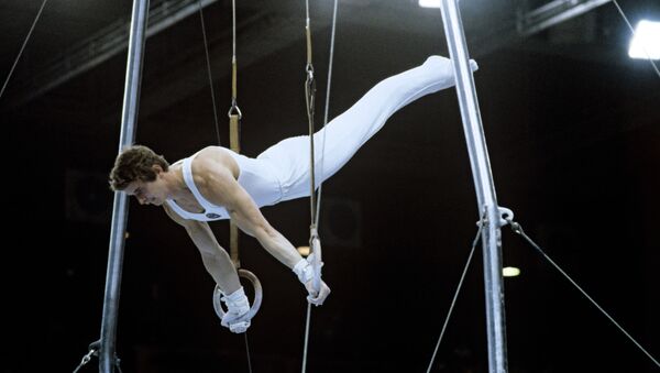 Александр Дитятин, абсолютный Олимпийский чемпион 1980 года по спортивной гимнастике, выполняет упражнение на кольцах. XXII летние Олимпийские игры. - Sputnik Южная Осетия