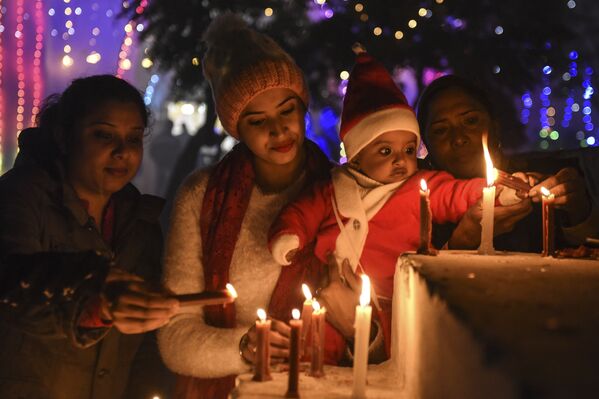 Верующие зажигают свечи в канун Рождества в соборе в Амритсаре, Индия  - Sputnik Южная Осетия