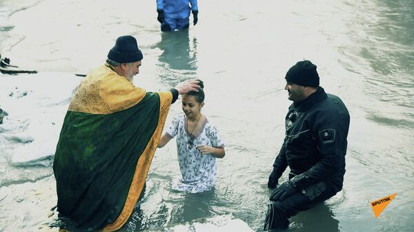 В Богоявление в реке Большая Лиахва крестились десятки человек – видео - Sputnik Южная Осетия