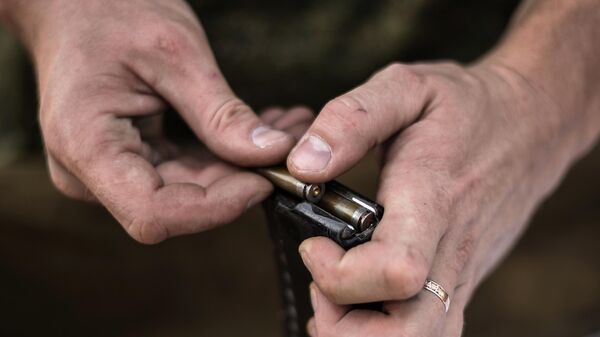 Мужчина заряжает магазин стреляными гильзами. Архивное фото  - Sputnik Южная Осетия
