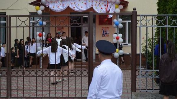 Сотрудники МВД Южной Осетии следят за правопорядком в школе во время проведения торжественного мероприятия - Sputnik Южная Осетия