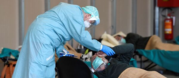 Врач помогает пациенту во временной больнице в Брешиа, Италия Врач помогает пациенту во временной больнице в Брешиа, Италия - Sputnik Южная Осетия