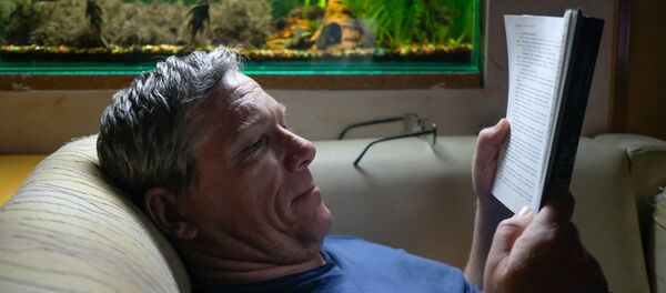Мужчина читает книгу во время самоизоляции Мужчина читает книгу во время самоизоляции - Sputnik Южная Осетия