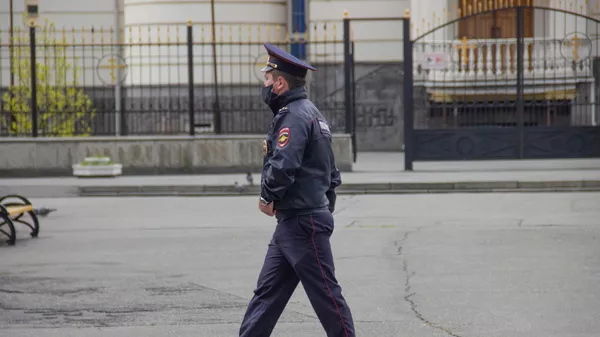 Сотрудник полиции в медицинской маске во Владикавказе. Архивное фото 