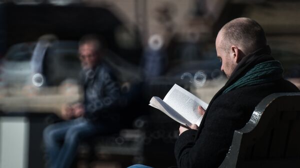 Мужчина читает книгу на скамейке в парке - Sputnik Южная Осетия