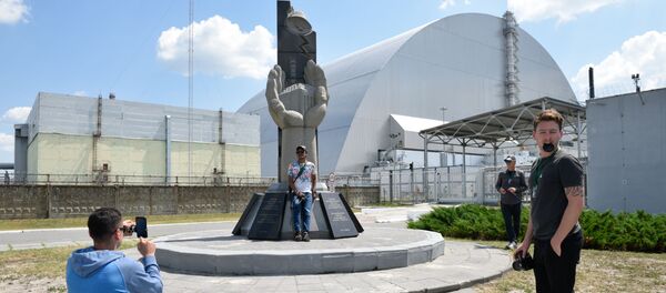 Туристы фотографируются возле памятника ликвидаторам аварии на Чернобыльской атомной электростанции имени Владимира Ильича Ленина  во время экскурсии в зону отчуждения в городе Чернобыль Туристы фотографируются возле памятника ликвидаторам аварии на Чернобыльской атомной электростанции имени Владимира Ильича Ленина  во время экскурсии в зону отчуждения в городе Чернобыль - Sputnik Южная Осетия