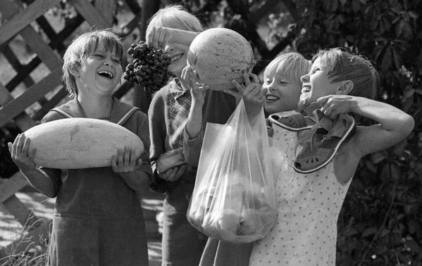 Воспитанники Ташкентского детского дома держат в руках дыню, арбуз, виноград и персики, которые они сами вырастили на своем приусадебном участке, 1983 год - Sputnik Южная Осетия